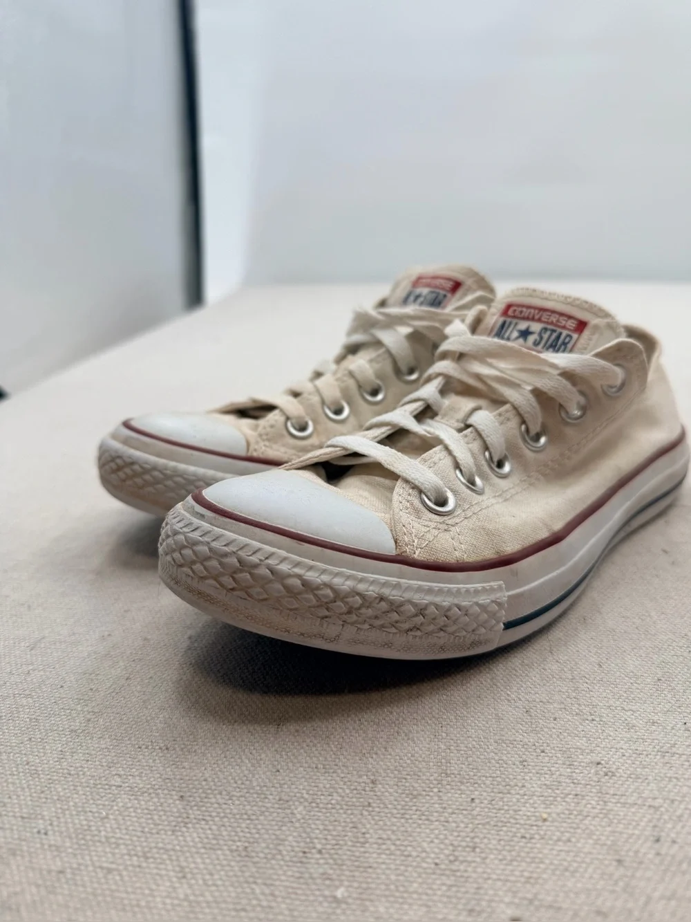 Converse Low Top Sneakers in Cream with Red Trim